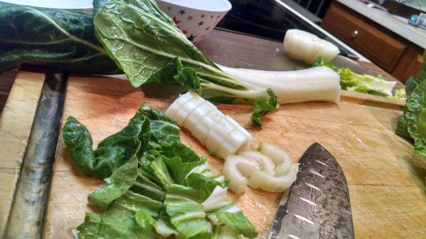 Chopping the bok choy stalks and leaves